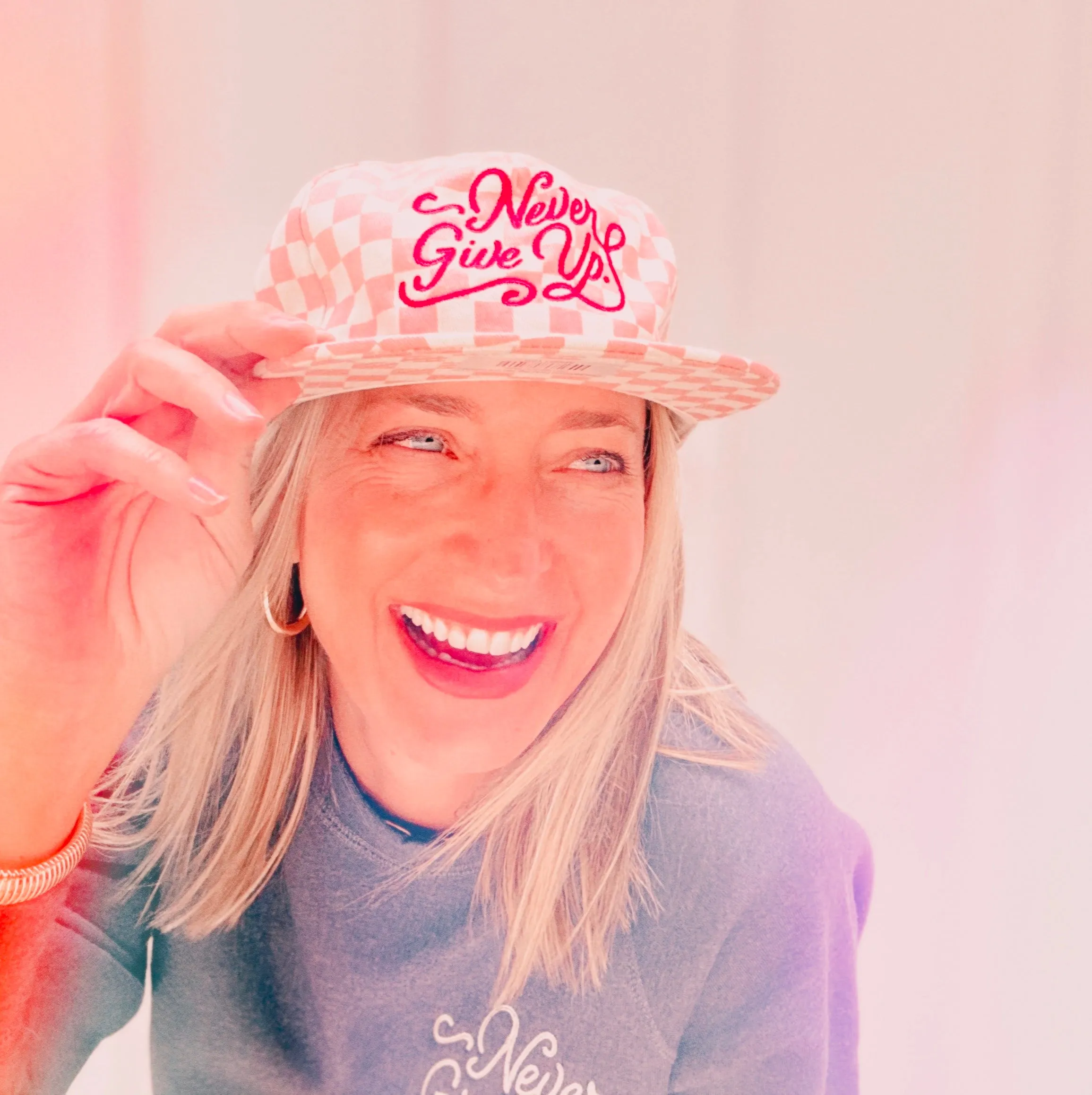 NEVER GIVE UP. PINK CHECKERED HAT