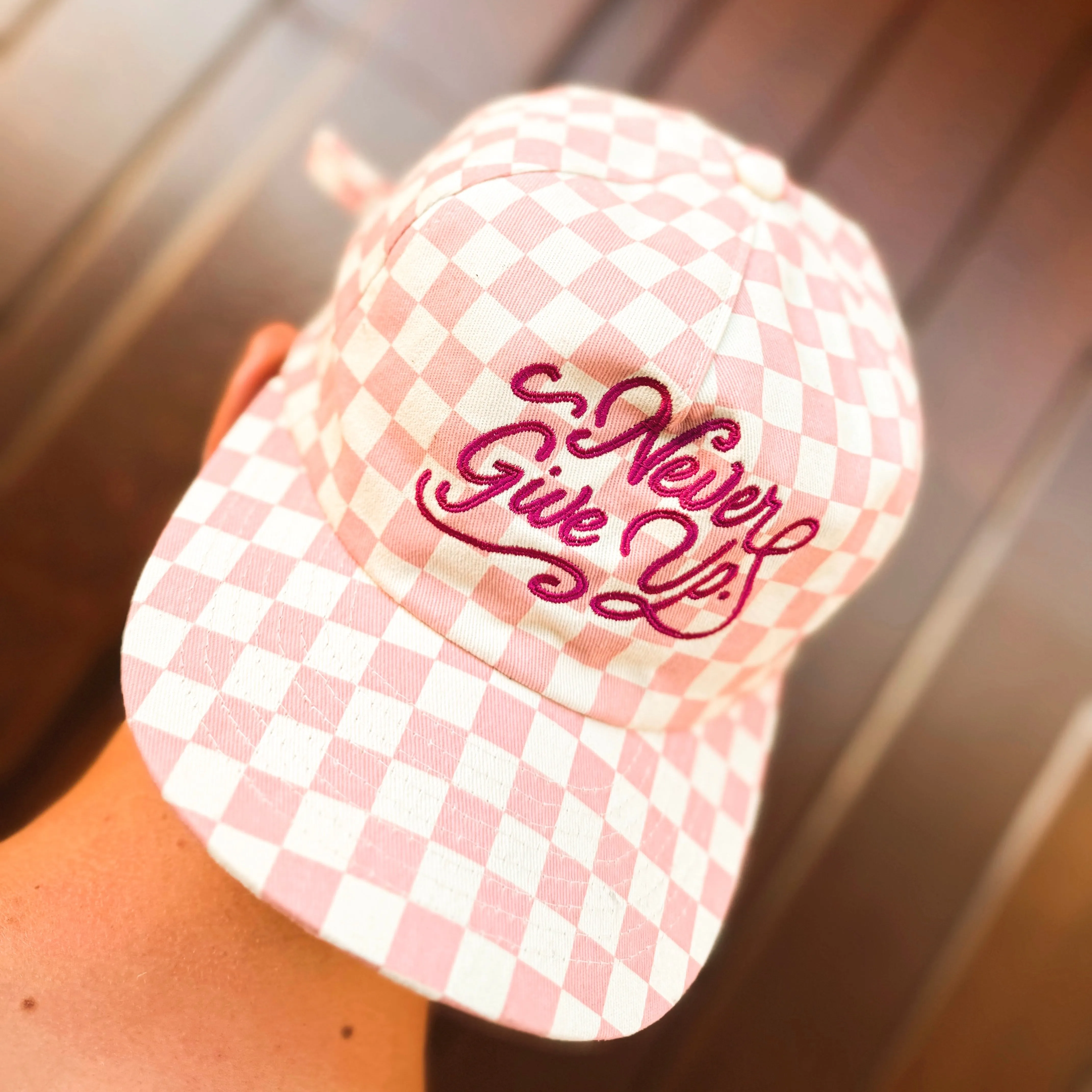 NEVER GIVE UP. PINK CHECKERED HAT